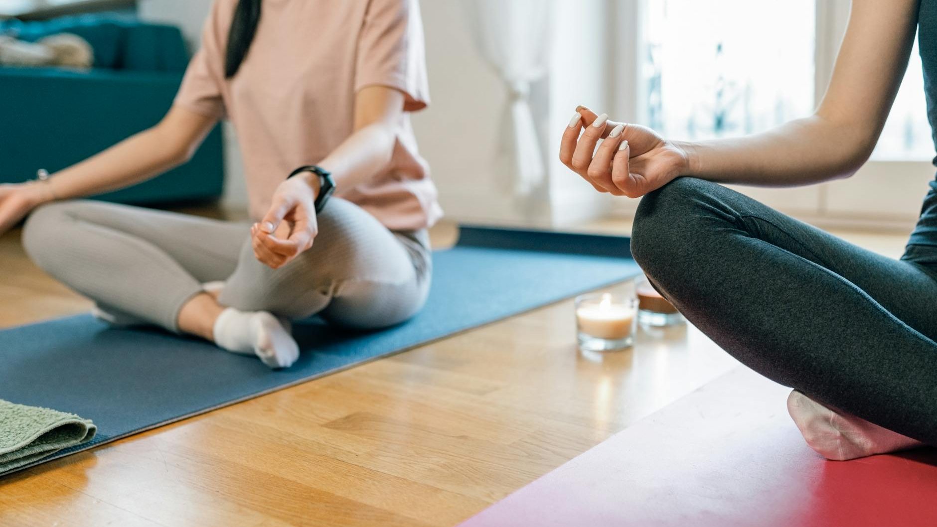 two people sitting on yoga mats